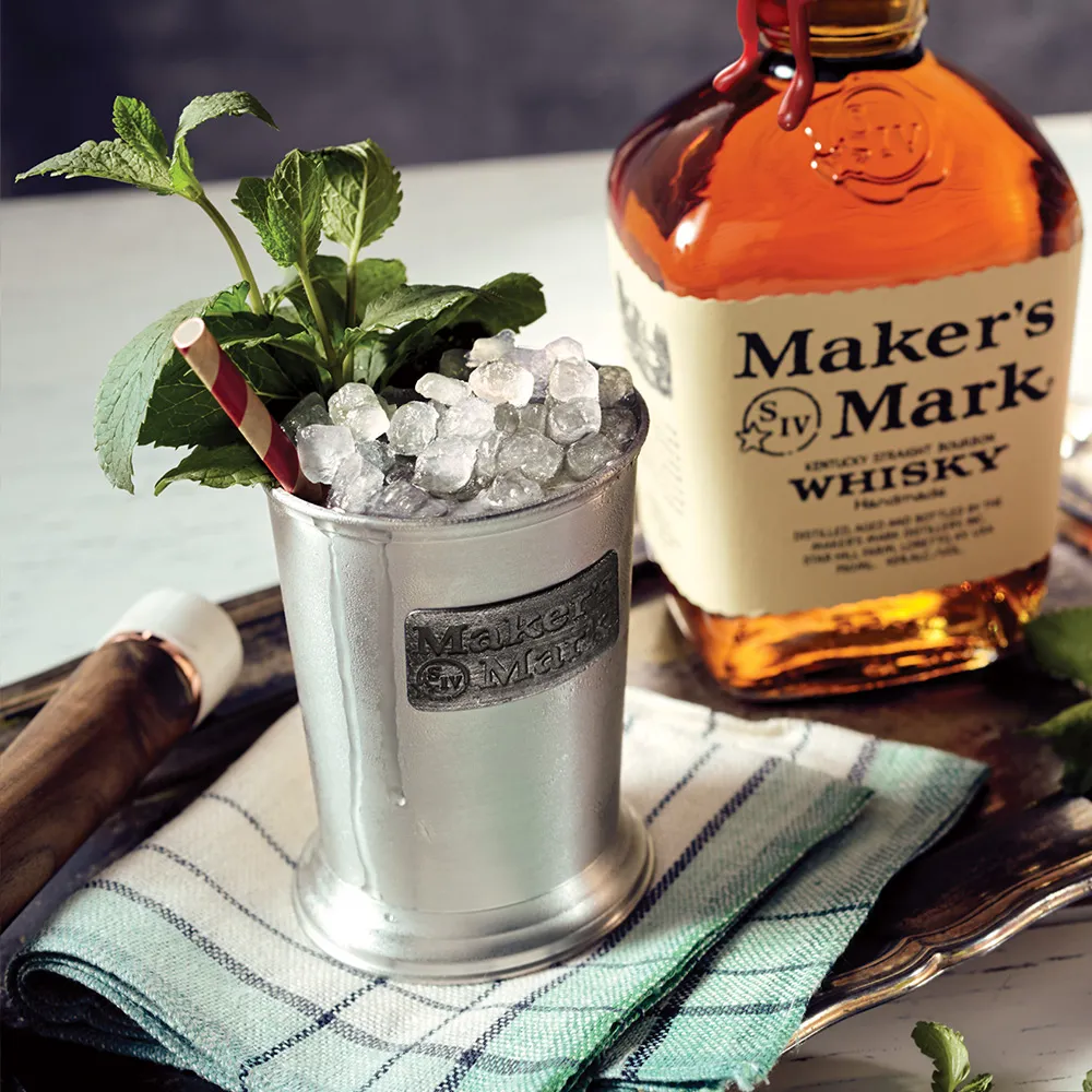 Maker's Mark mint julep in a metal cup and iced to perfection with mint sprigs